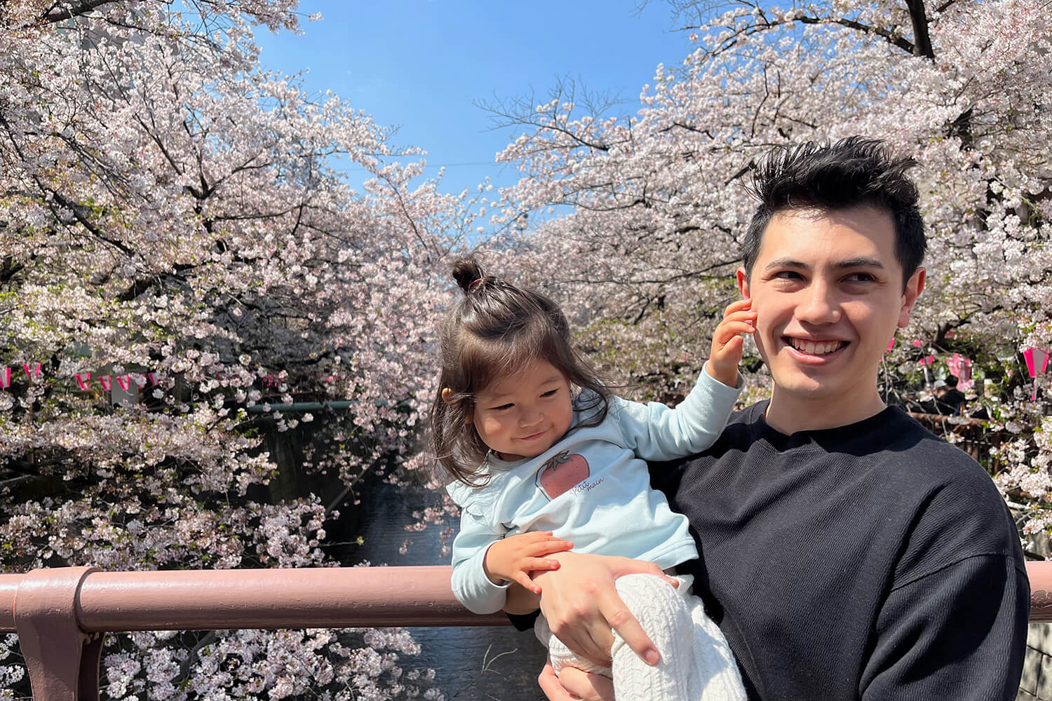 Sho Sacks holding daughter at Meguro River